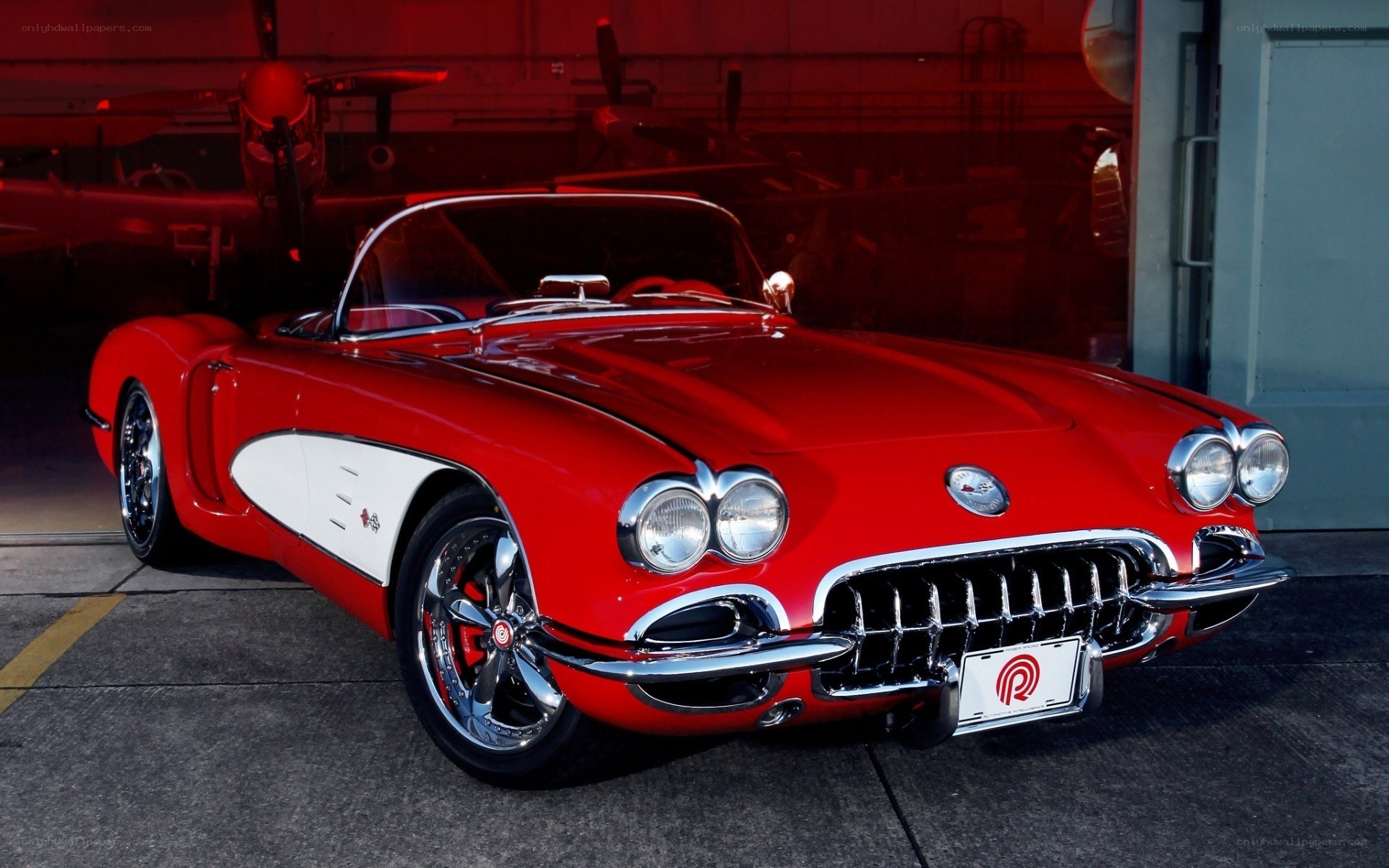 Red classic Corvette in hangar
