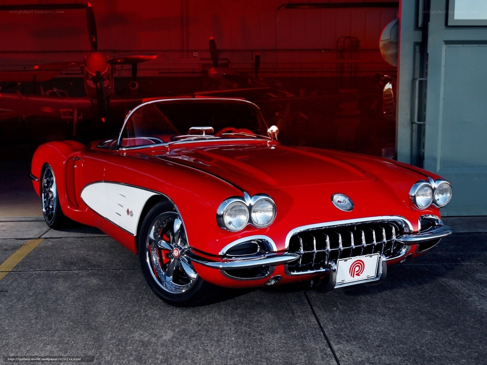 Red classic Corvette in hangar