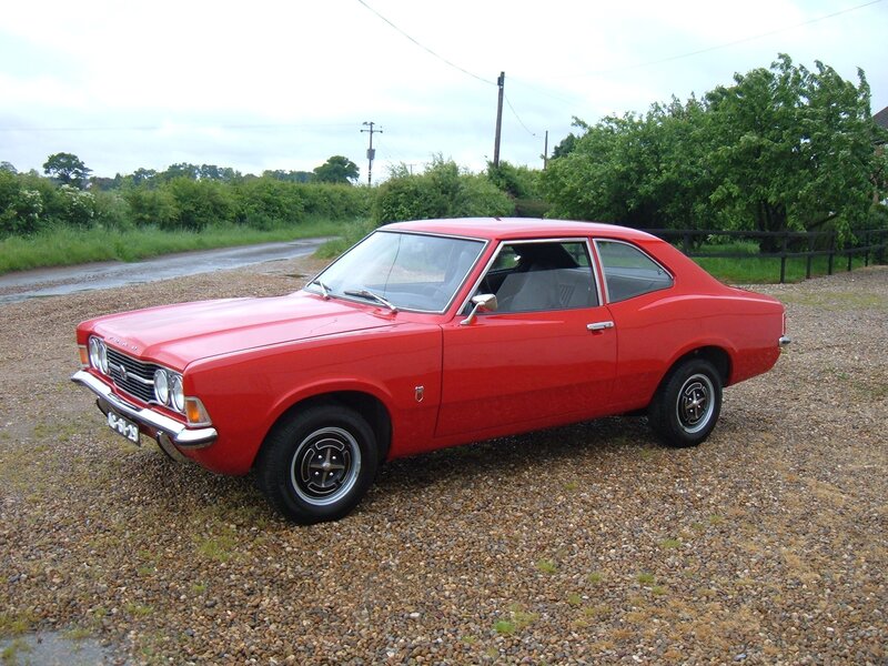 Red classic coupe on gravel