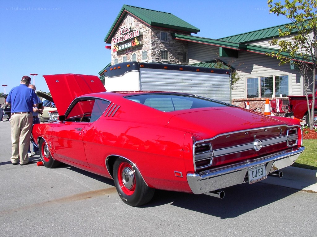 Red classic muscle car at a show