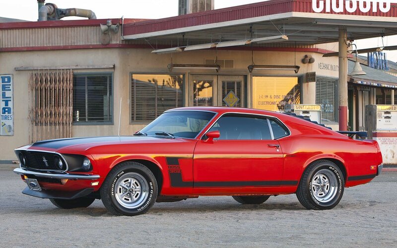 Red classic muscle car at gas station