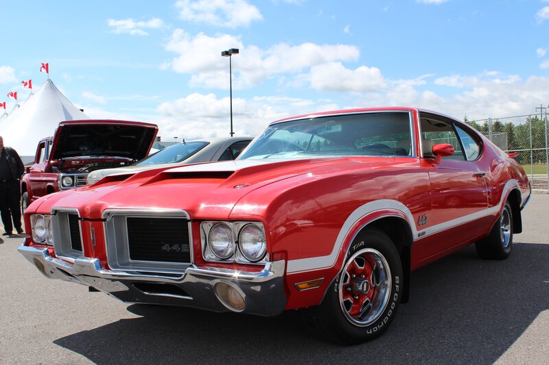 Red classic muscle car at show