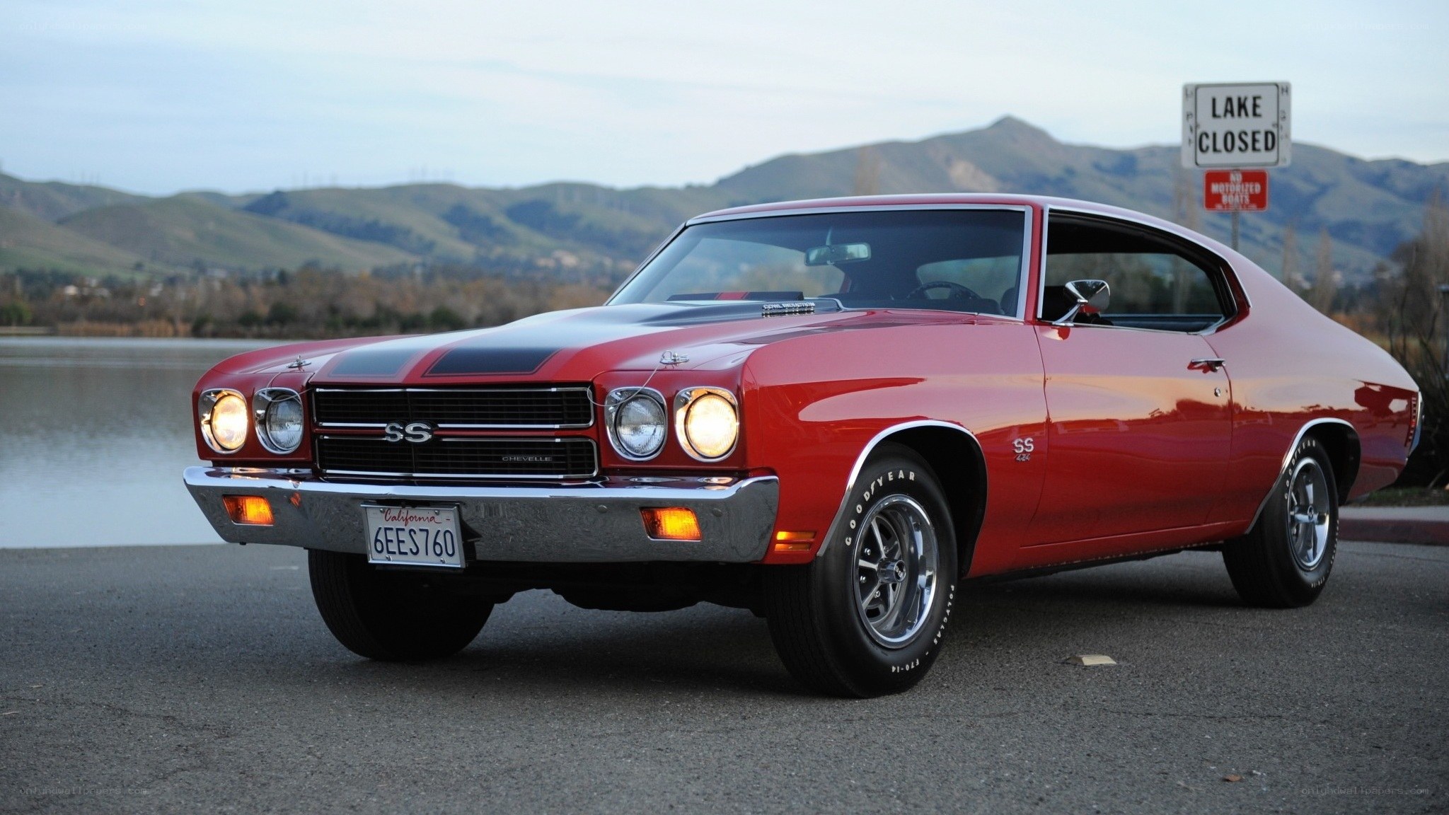 Red classic muscle car by lake