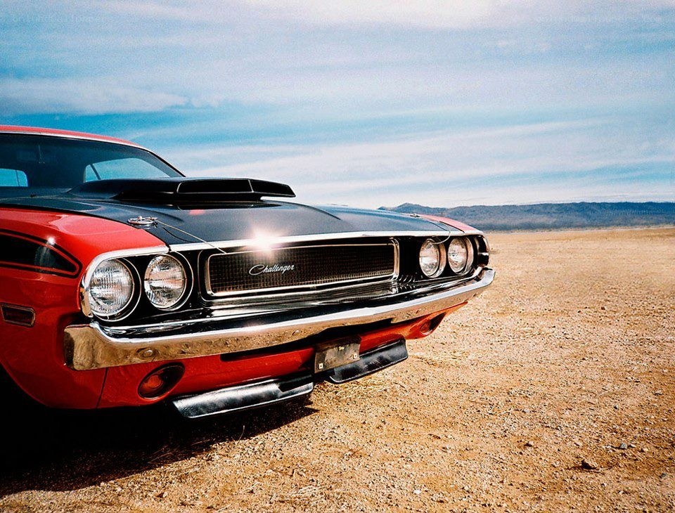 Red classic muscle car in desert
