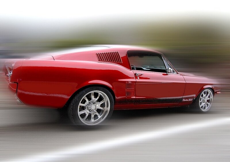 Red classic muscle car in motion