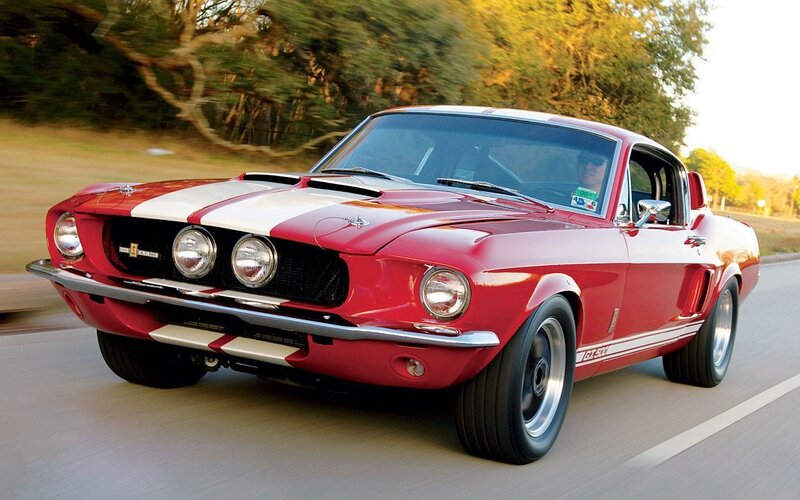 Red classic muscle car in motion