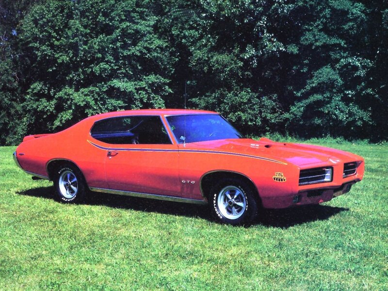 Red classic muscle car on grass