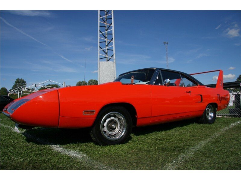 Red classic muscle car on grass