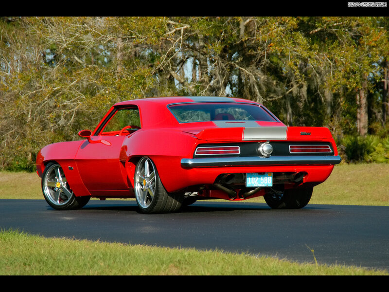 Red classic muscle car on road