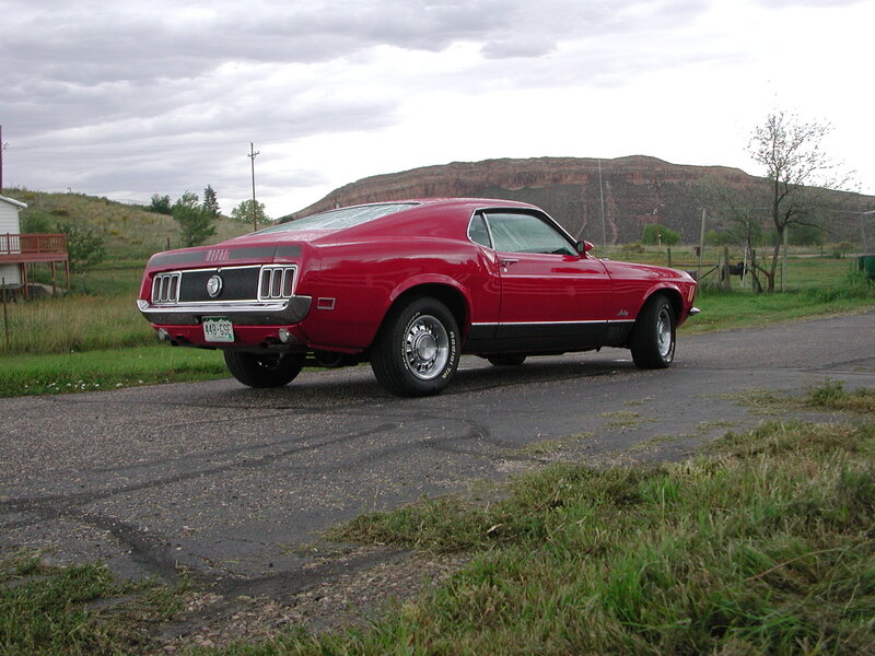 Red classic muscle car on road