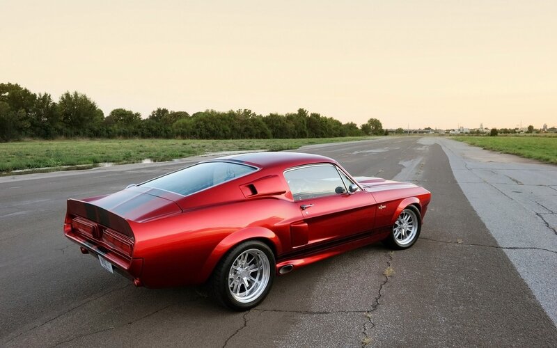Red classic muscle car on road