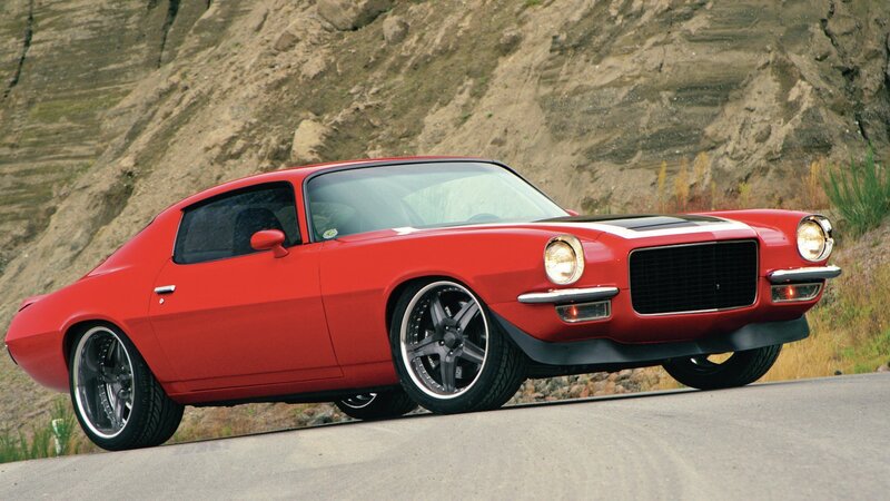 Red classic muscle car on road