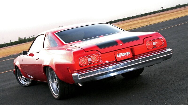red classic muscle car on track