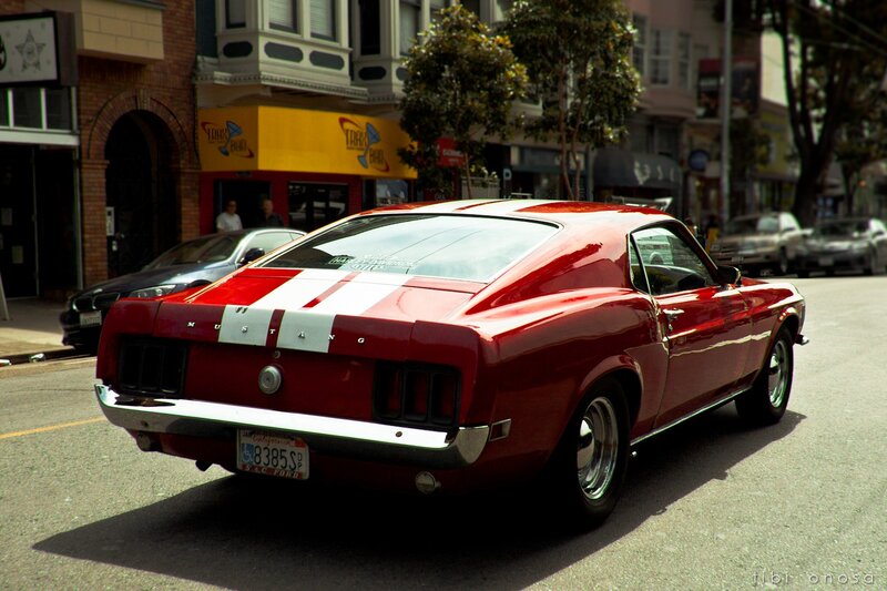 Red classic Mustang on city street