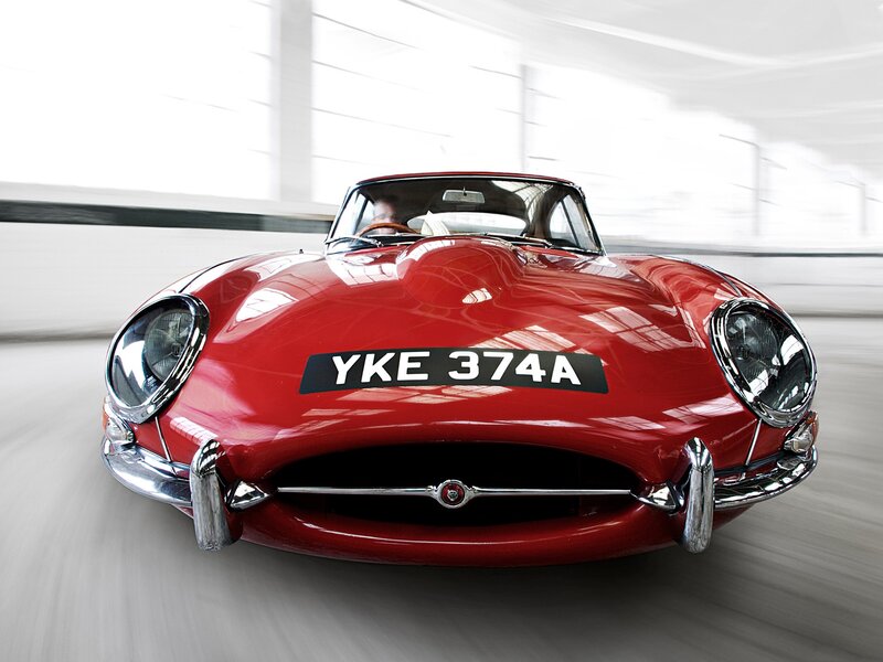 Red classic sports car in motion