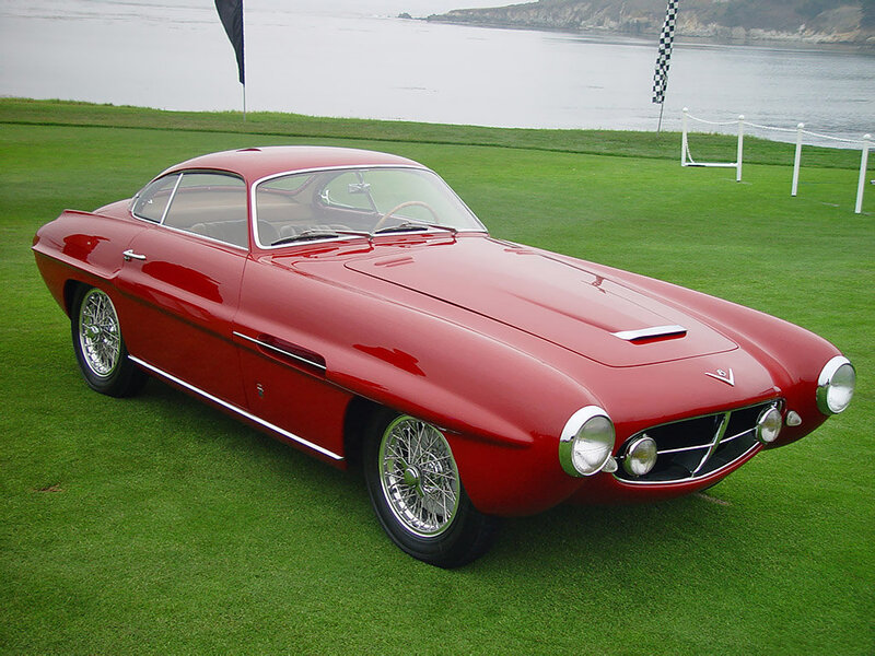Red classic sports car on grass
