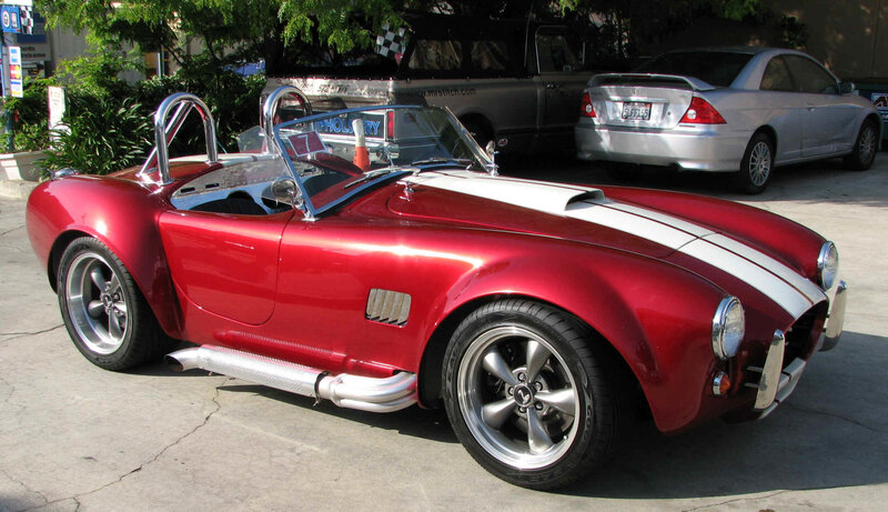 Red classic sports car with white stripes