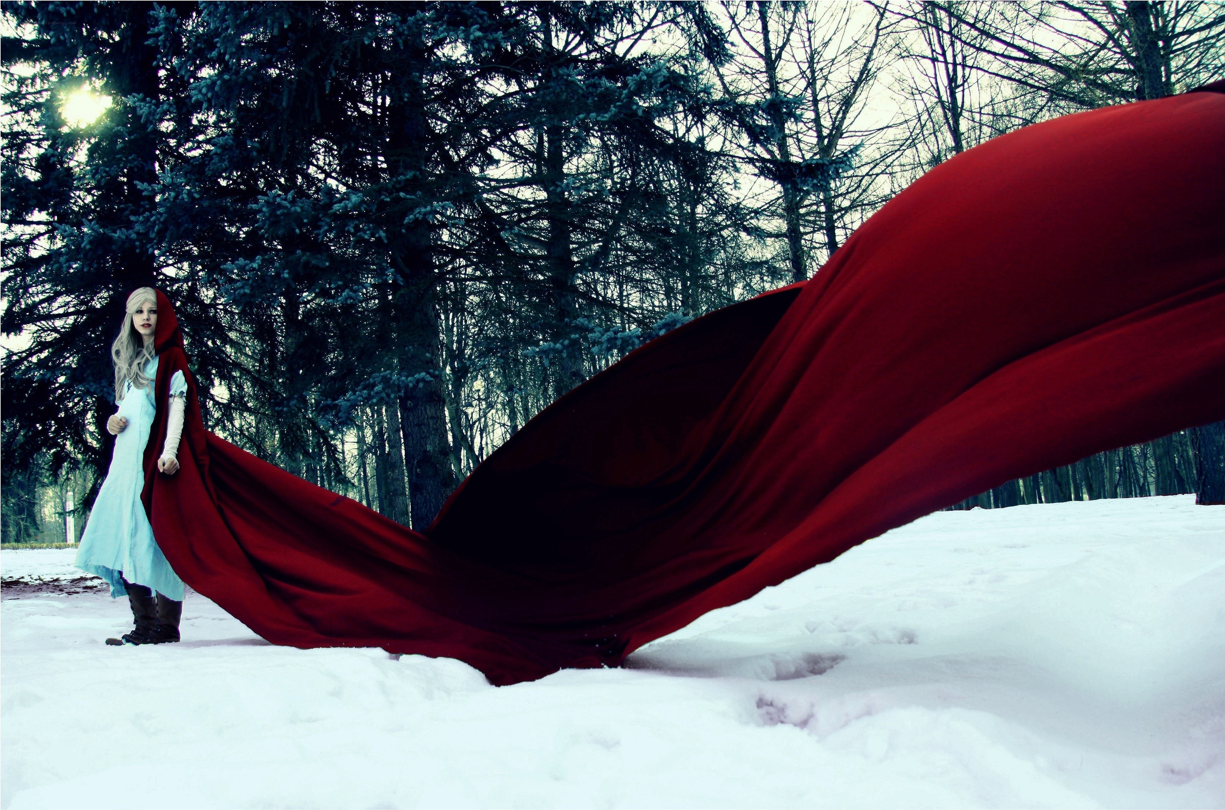 Red cloak in snowy forest