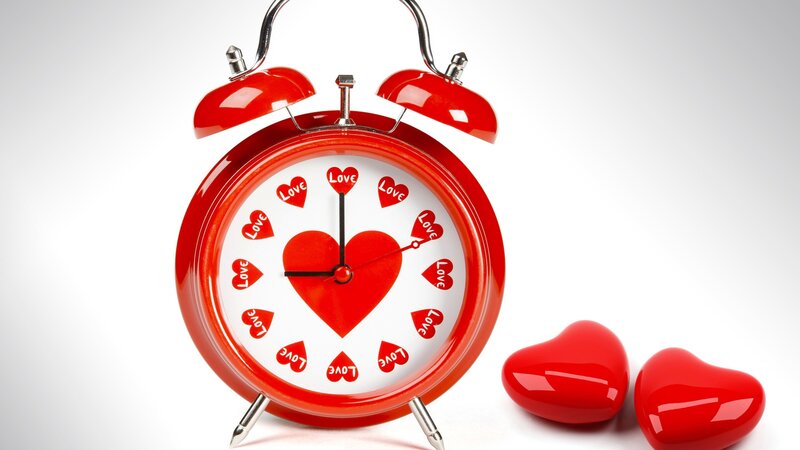 red clock with hearts