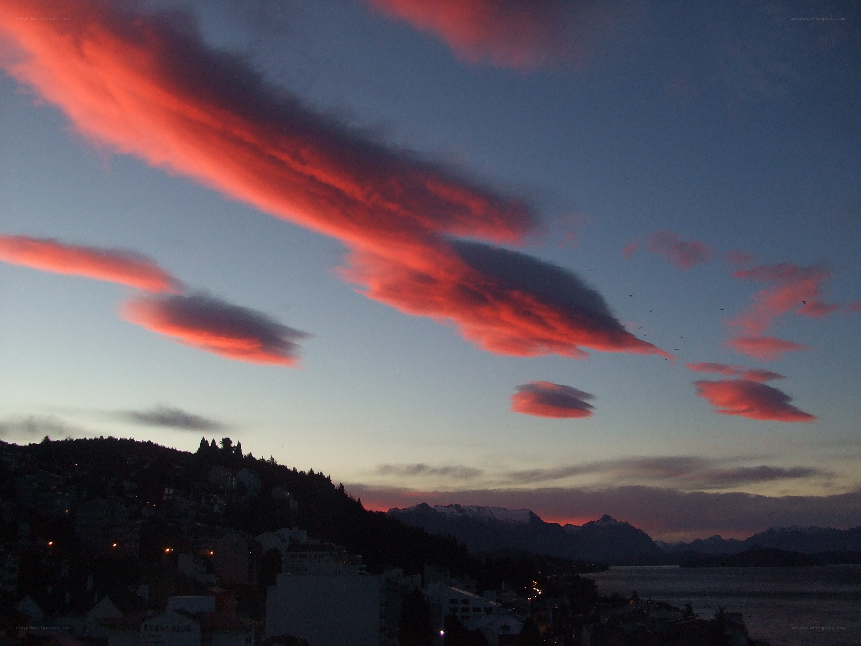 Red clouds over a coastal town