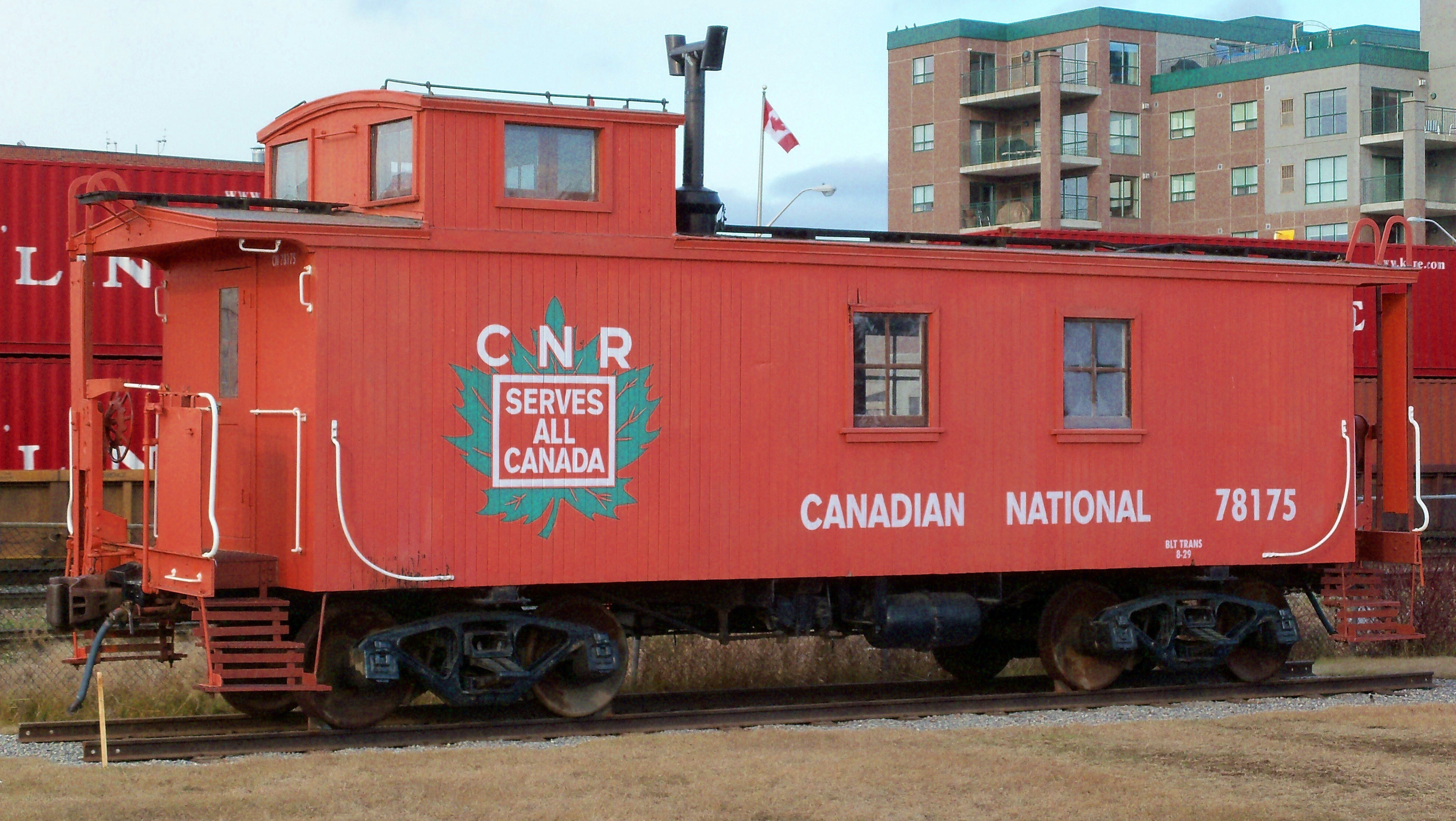 Red CNR caboose on tracks