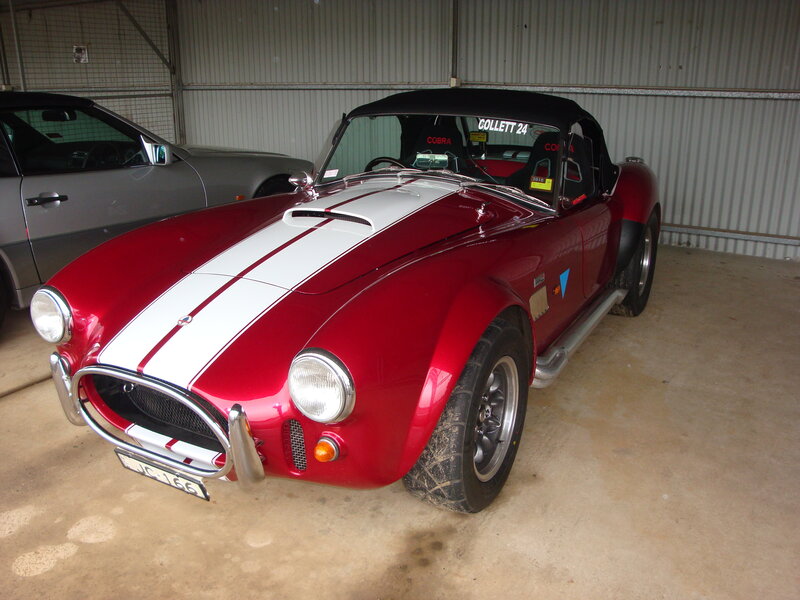 Red Cobra sports car in garage