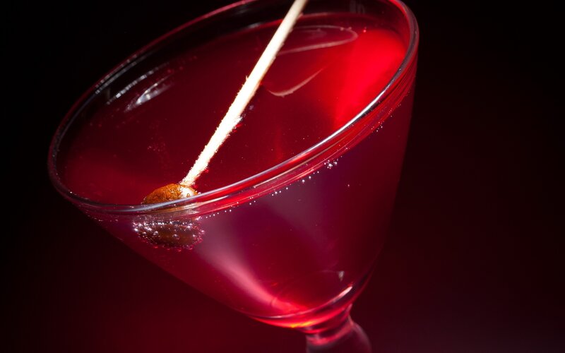 red cocktail in a martini glass