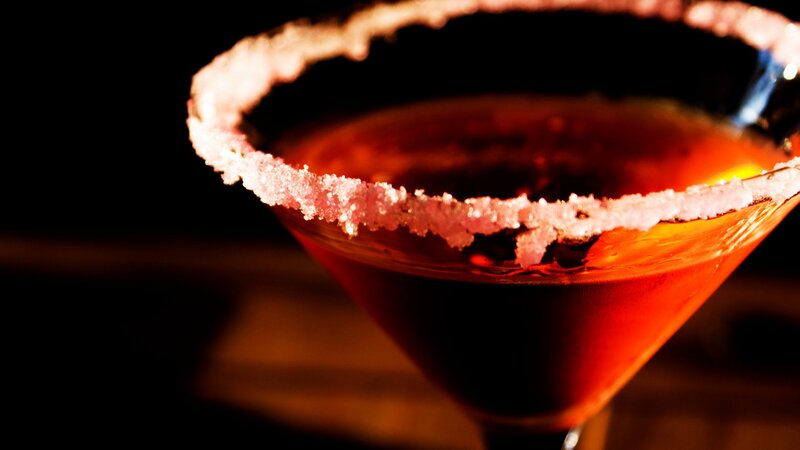 red cocktail in a martini glass