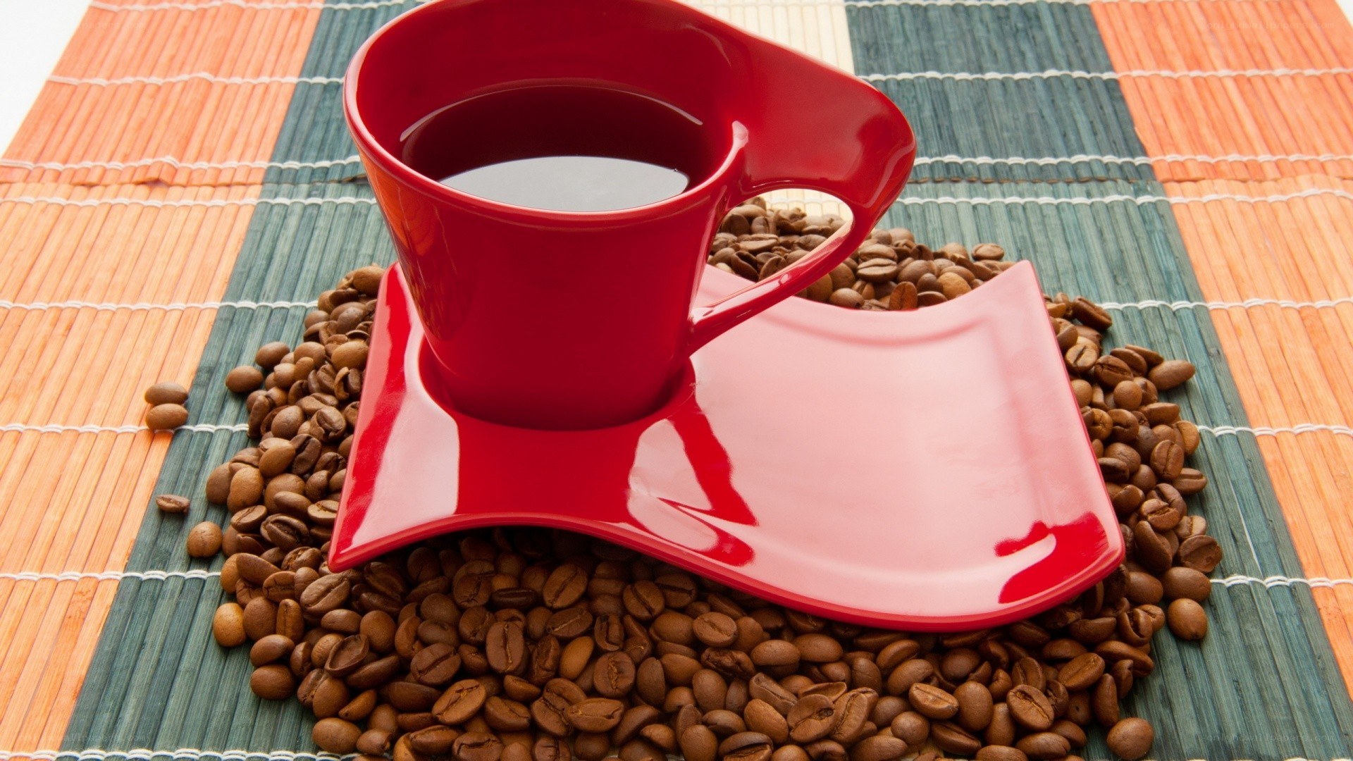 Red coffee cup on beans