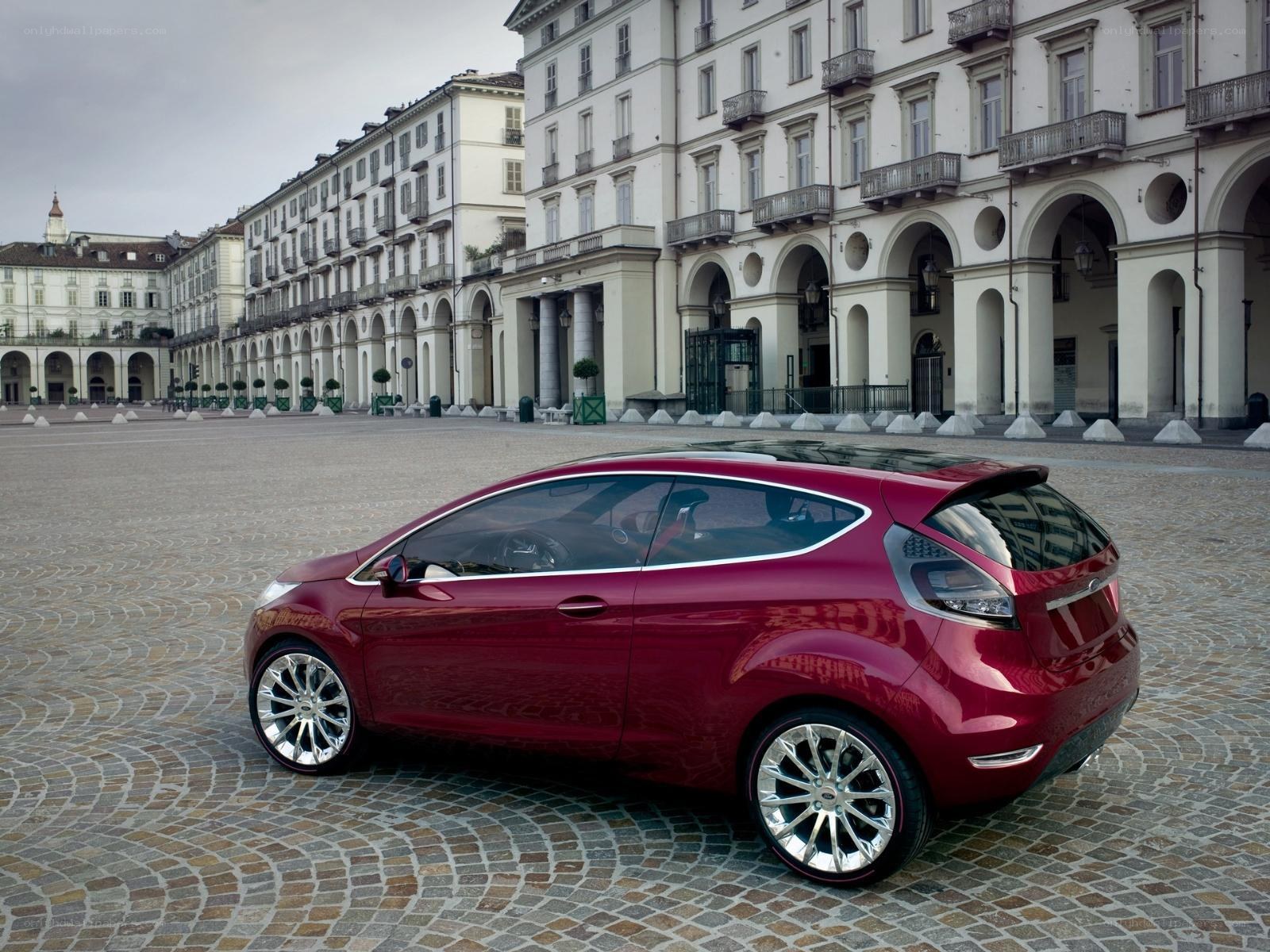 Red concept car in a city square