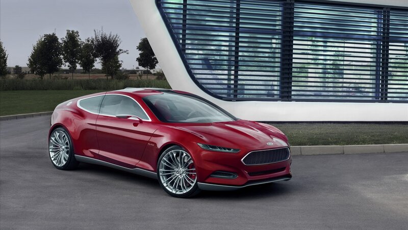 Red concept car in front of modern building