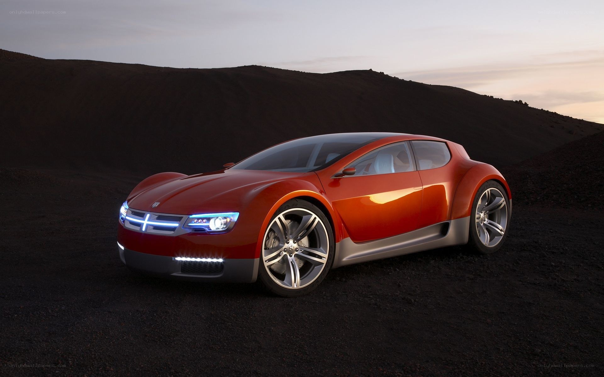 Red concept car on dark terrain