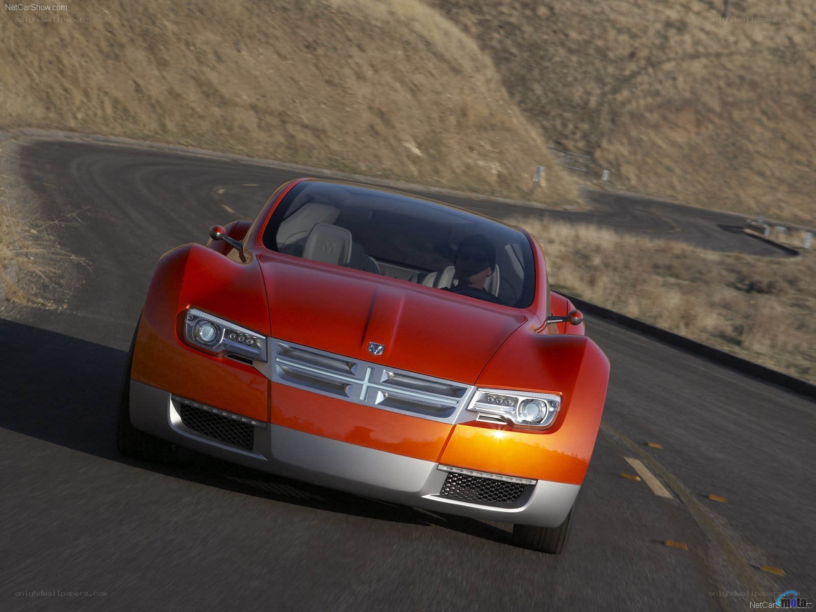 red concept car on winding road