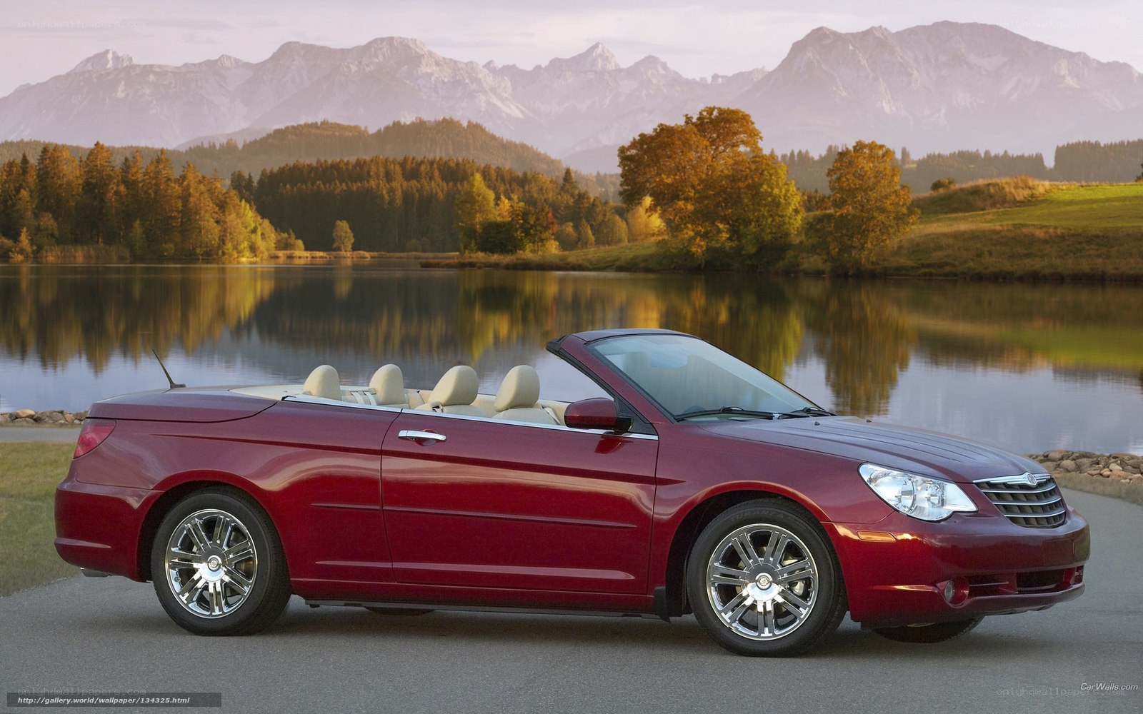 Red convertible by a lake