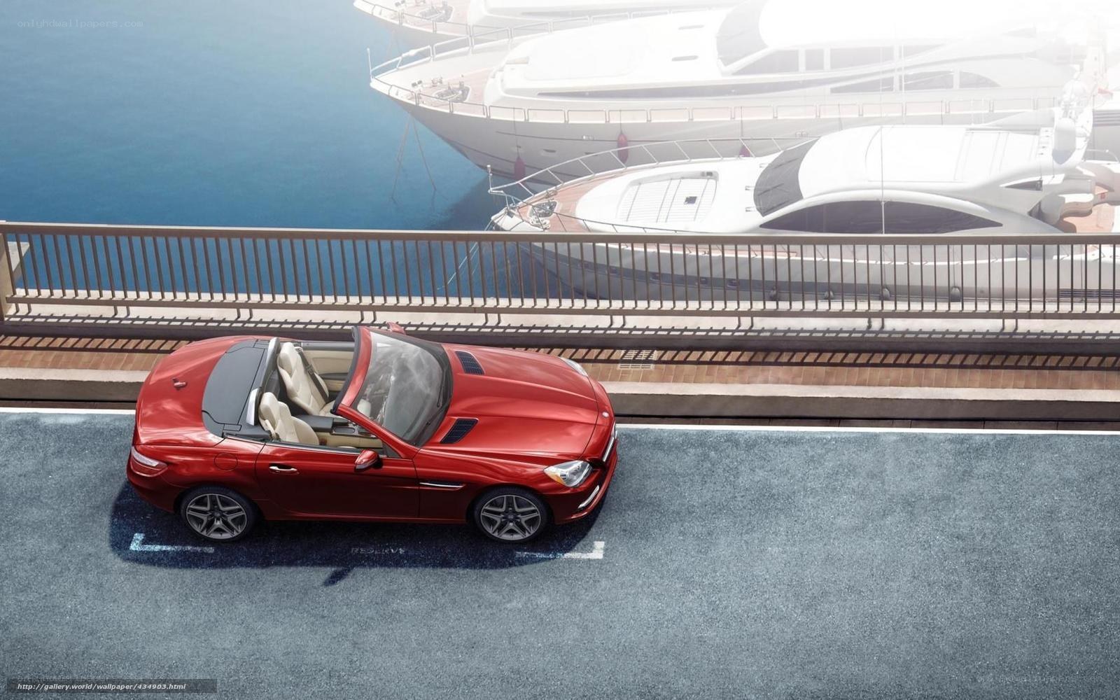 Red convertible by the marina