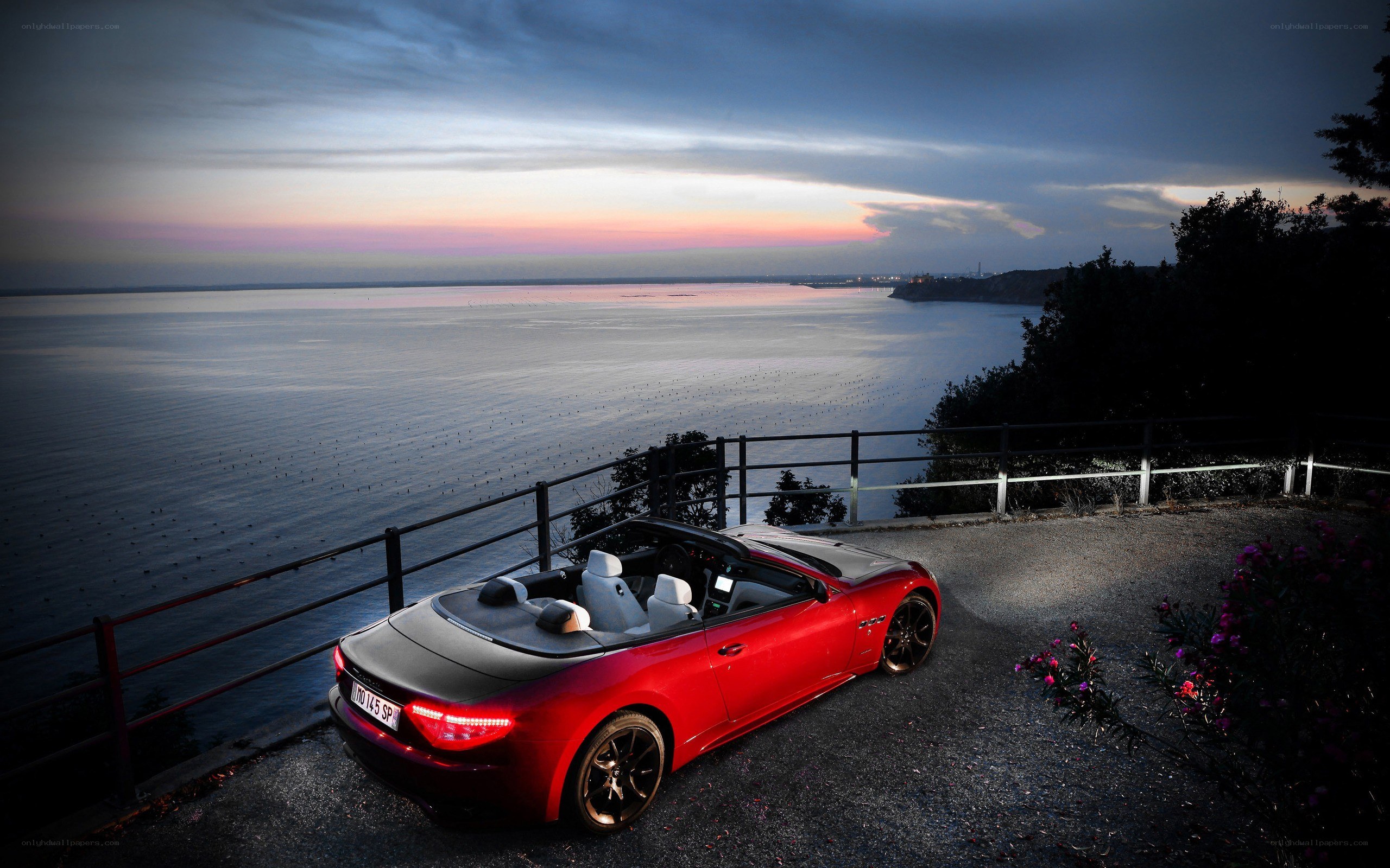 Red convertible by the sea