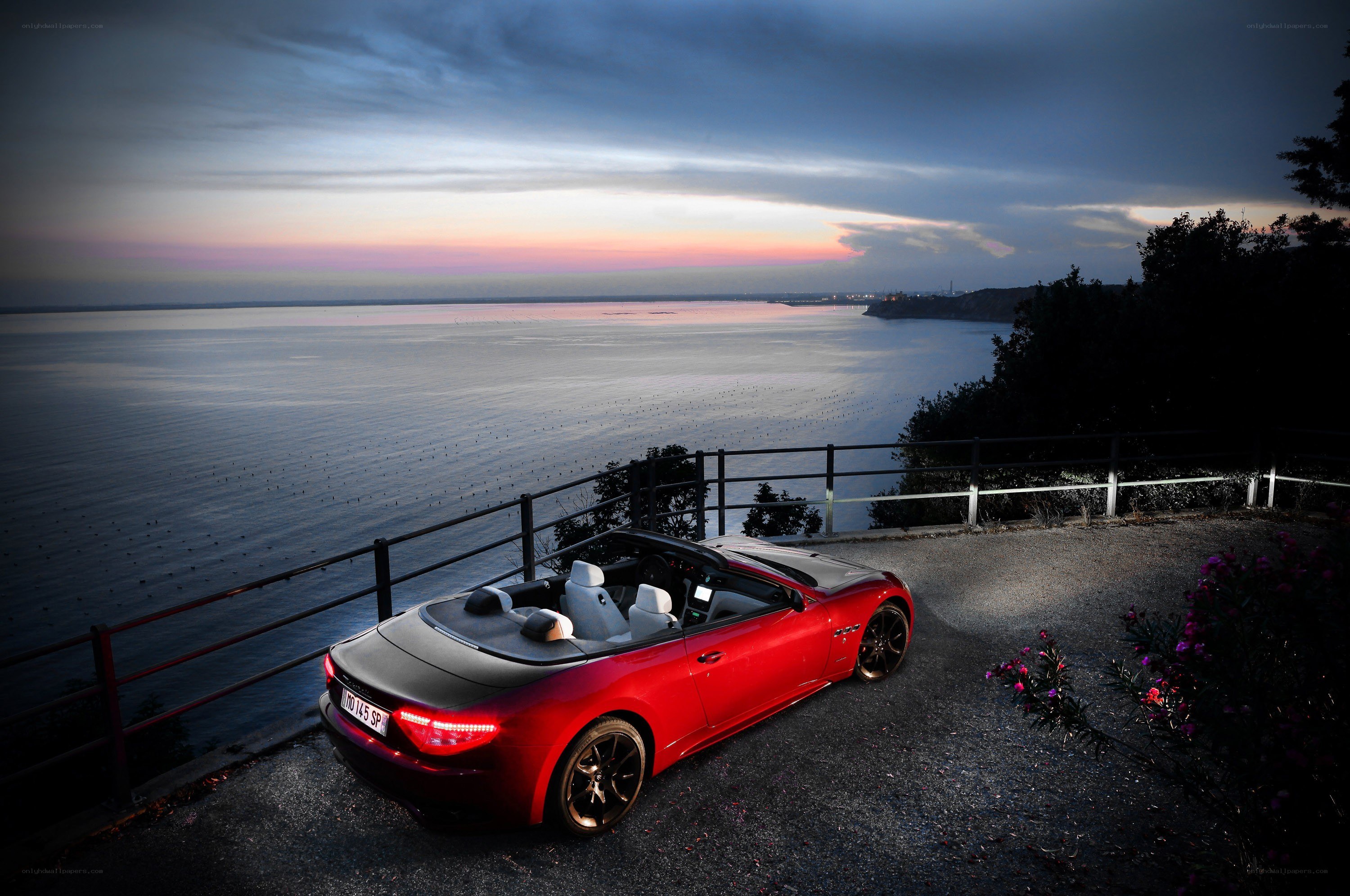 Red convertible by the sea