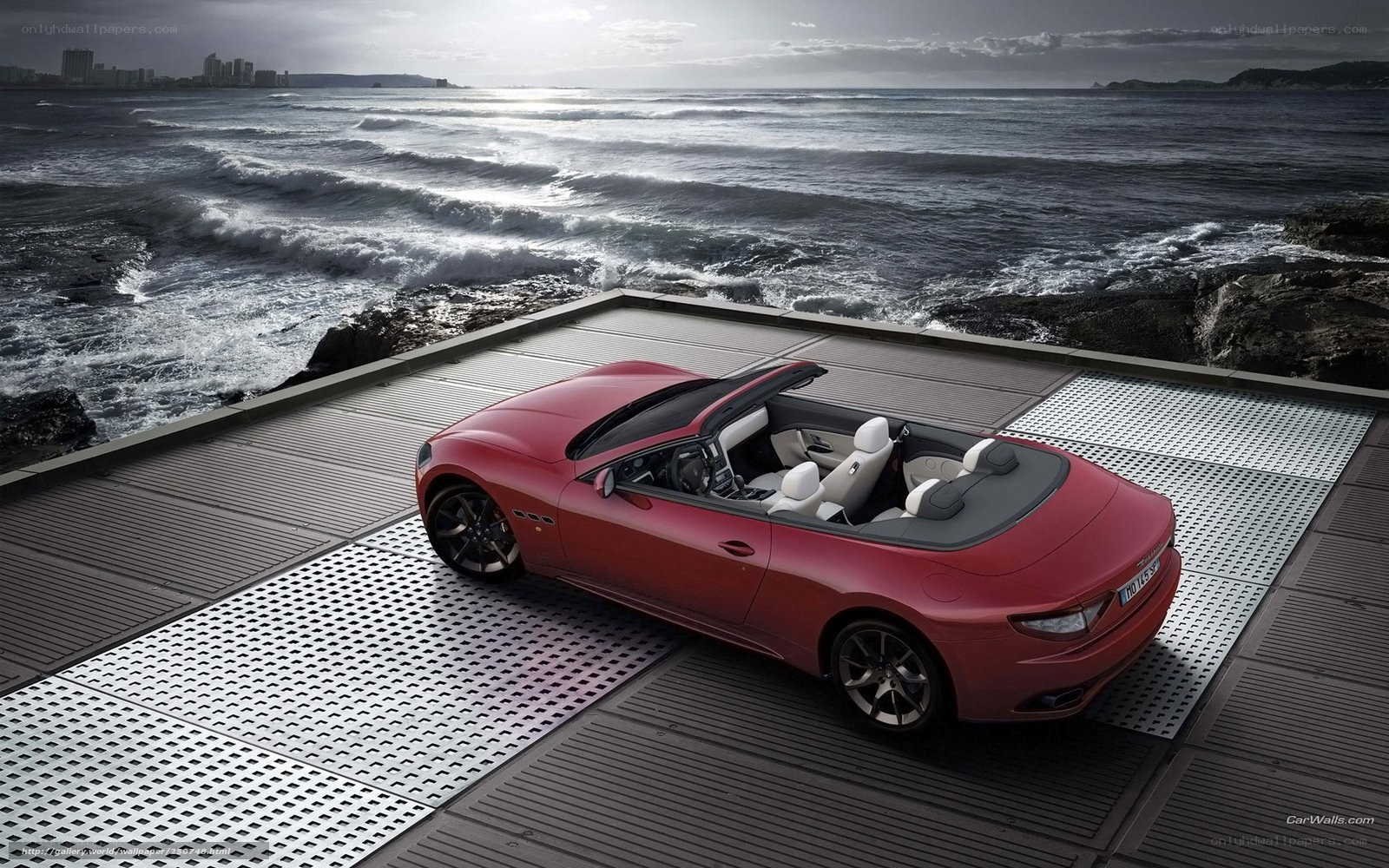 Red convertible by the sea