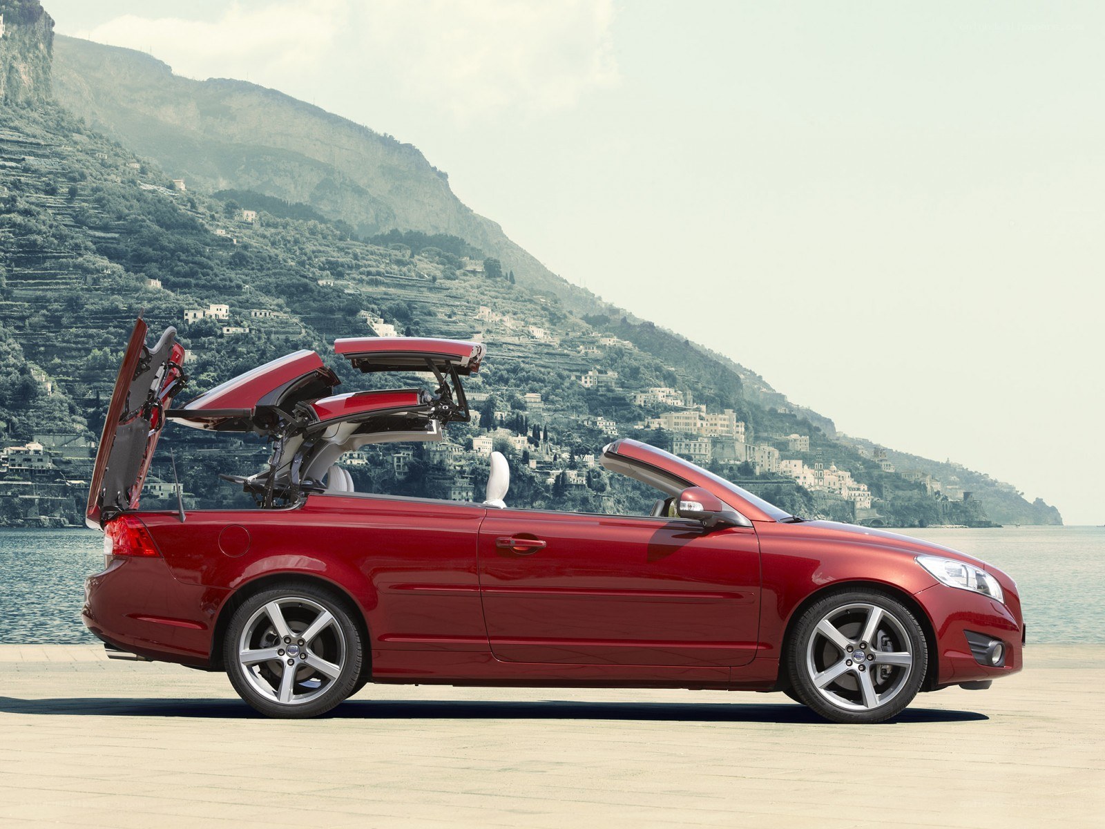 Red convertible car on coast