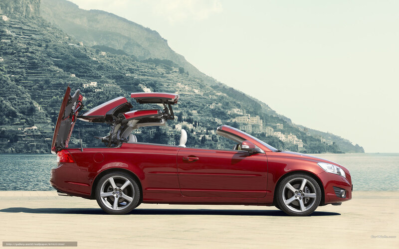 Red convertible car on coast