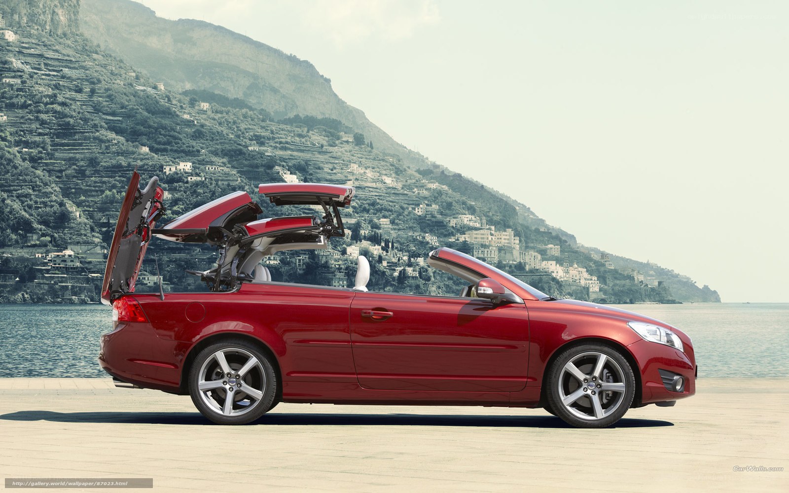 Red convertible car on coast