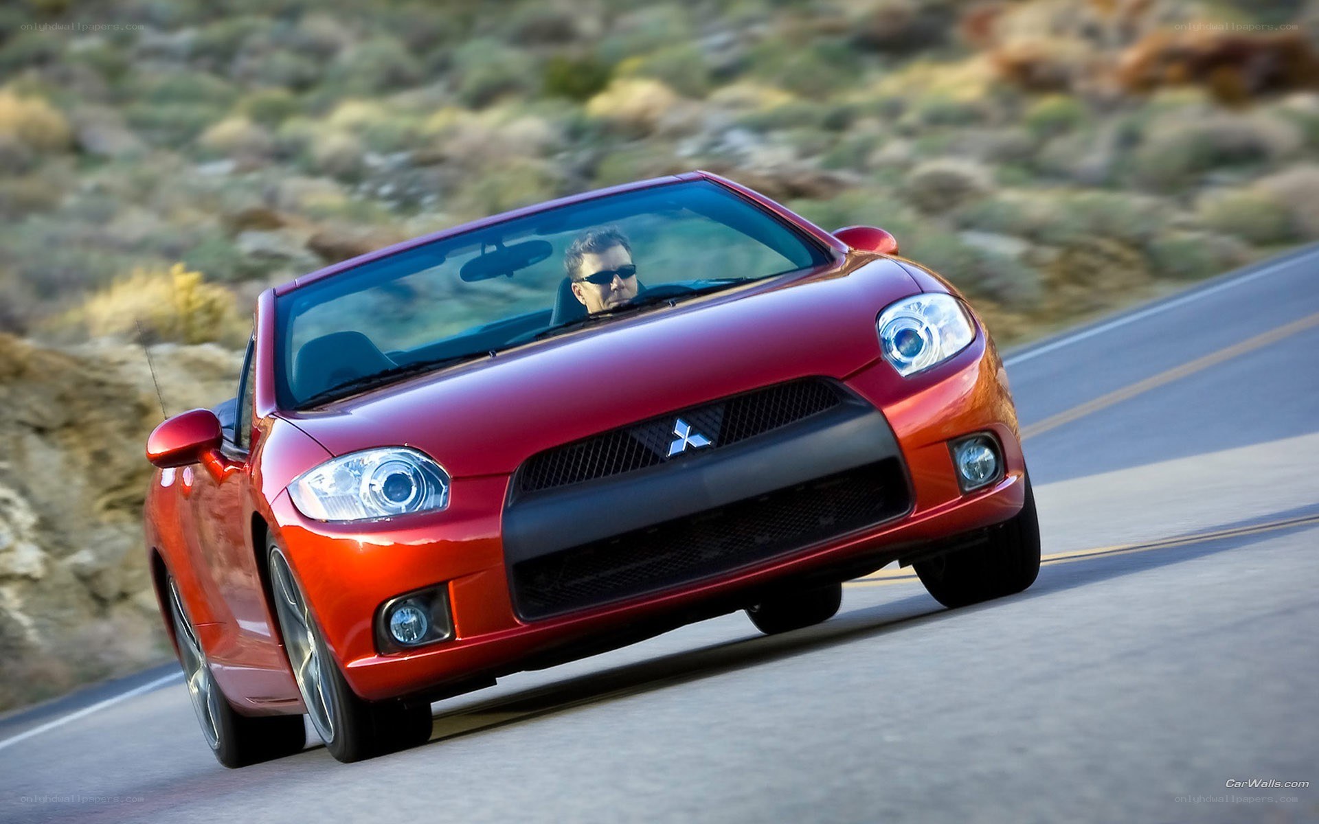 Red convertible driving on road