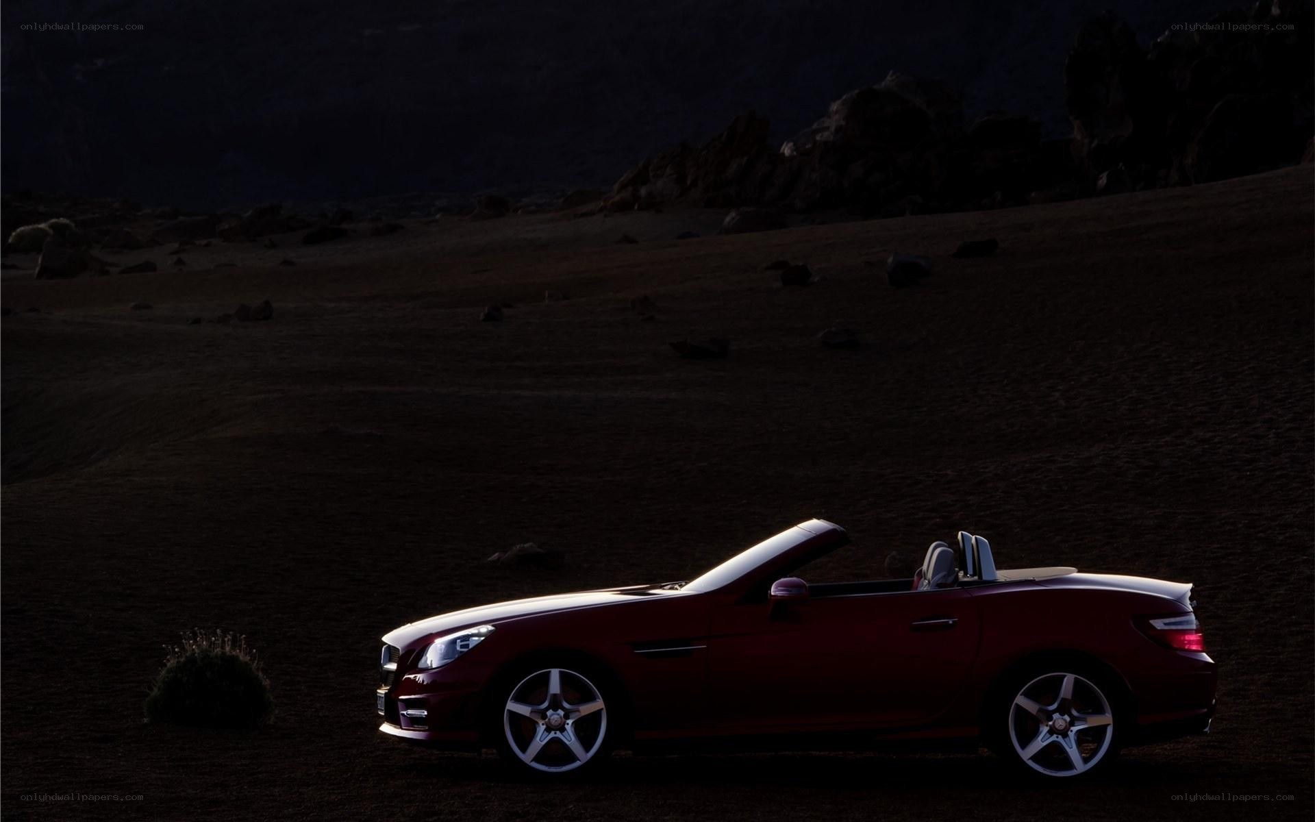 Red convertible in dark landscape