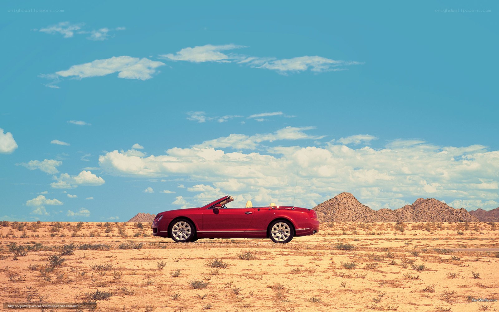 Red convertible in desert landscape