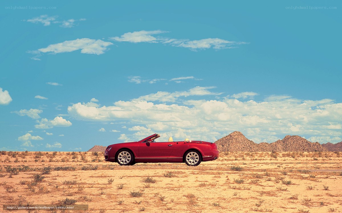 Red convertible in desert landscape