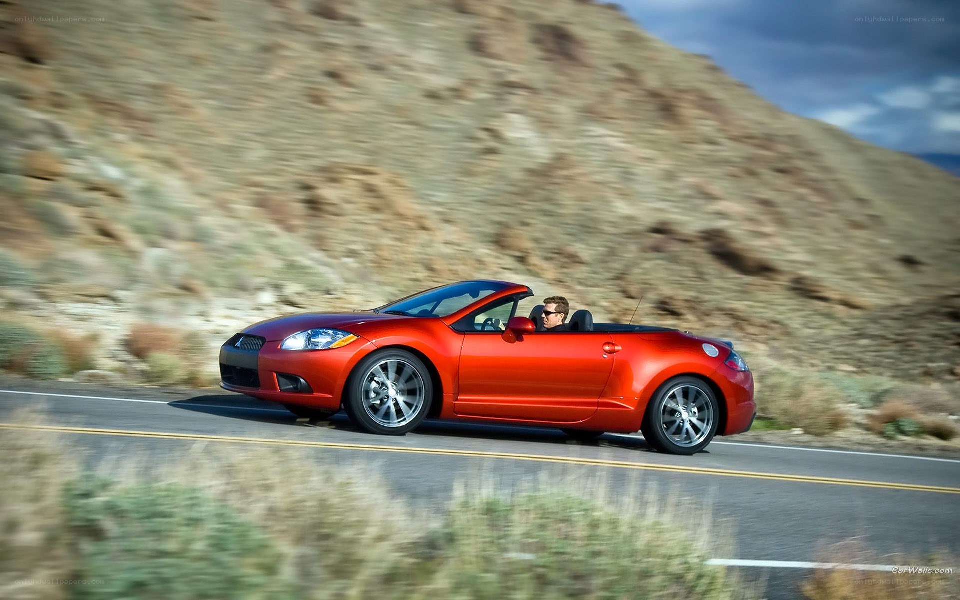 Red convertible on a mountain road
