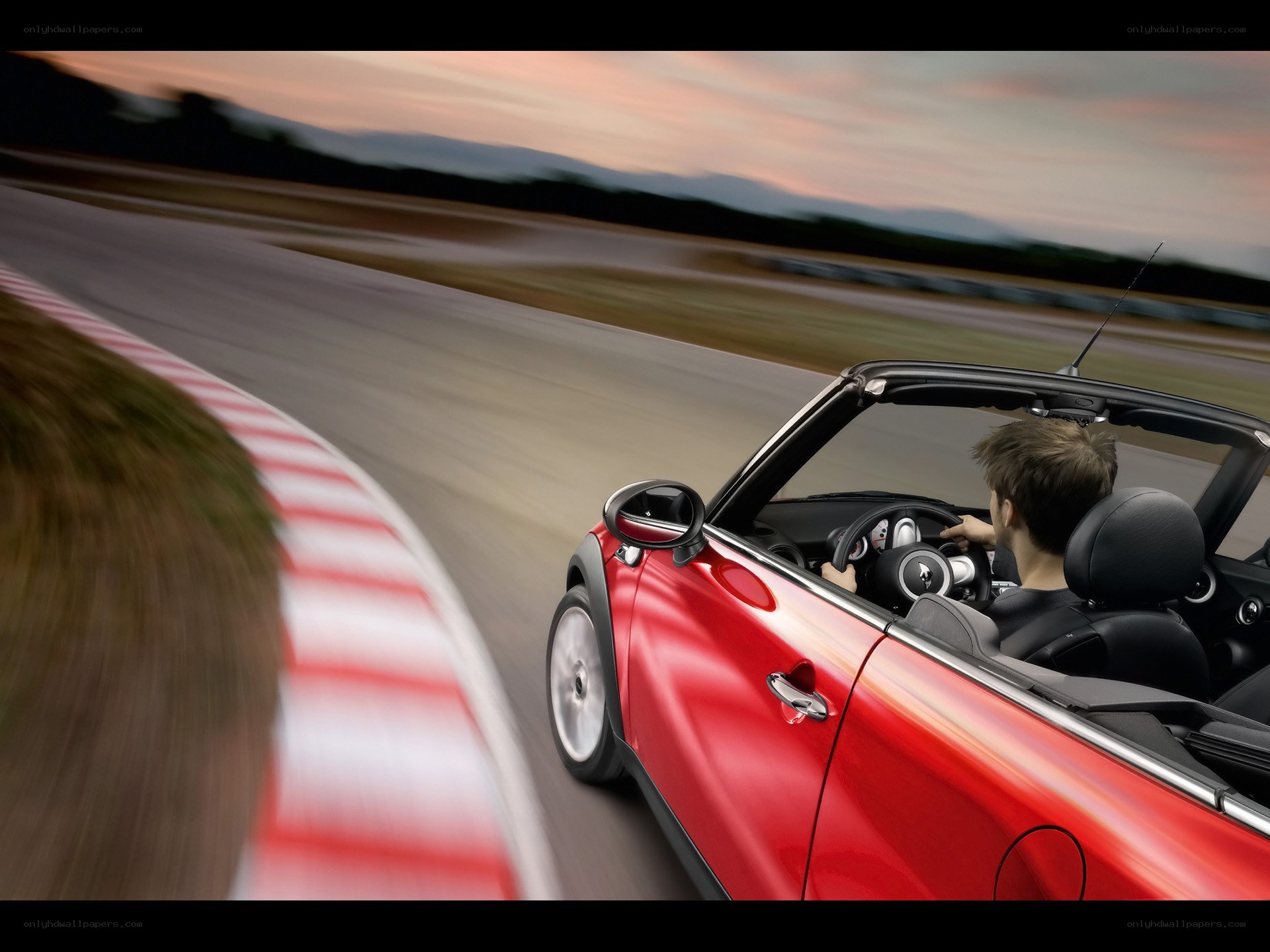 Red convertible on a racetrack