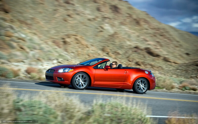 Red convertible on a scenic road