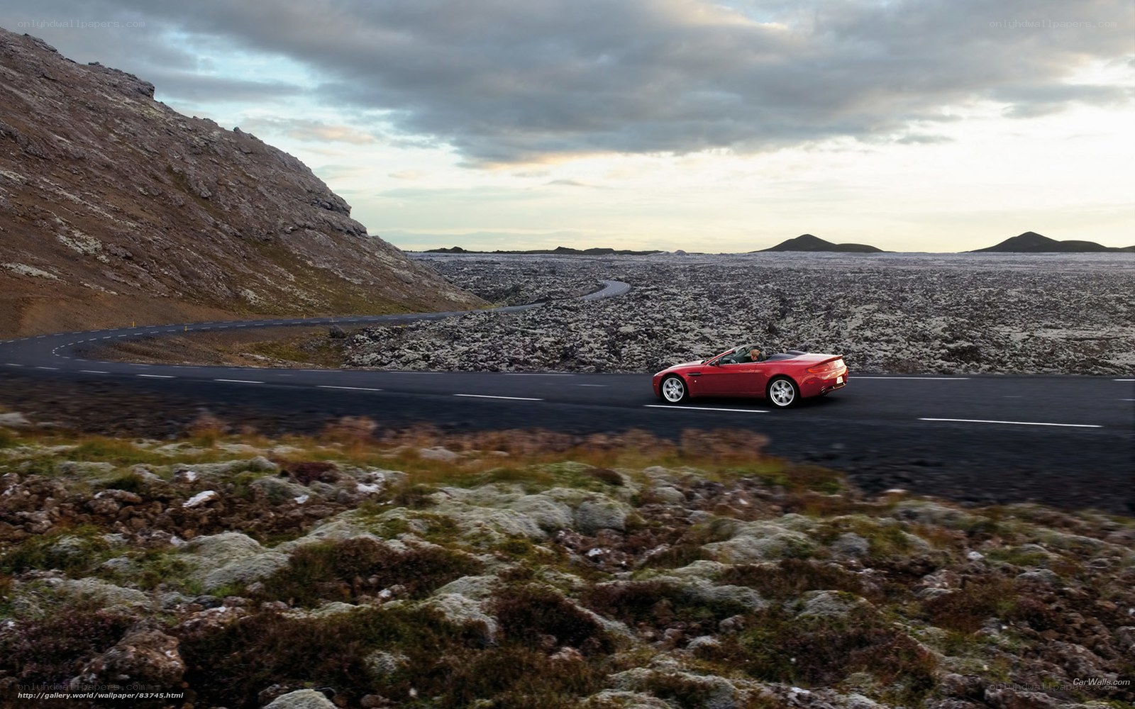 Red convertible on a winding road