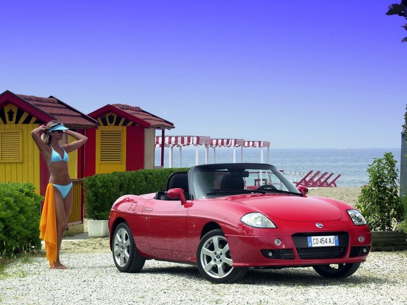 Red convertible on beach